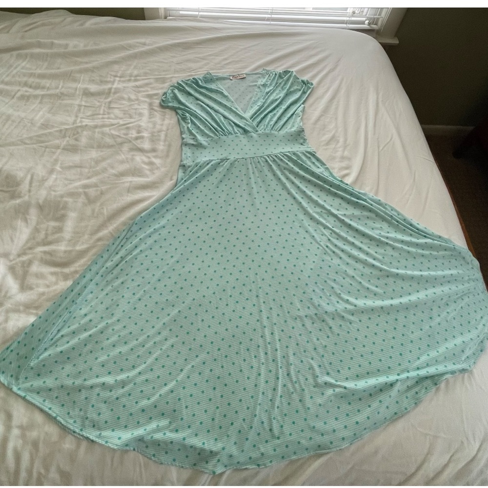 Turquoise dress with polka dots and a mild stripe pattern.